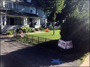 The front yard of Chip Pfleghaar's home in Perrysburg is adorned with his campaign signs.