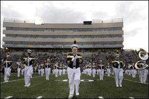 Virginia Todd, bottom center, cheers with other members of the the University of Toledo marching band during Thursday's  season opening football match up against Elon University at the Glass Bowl.