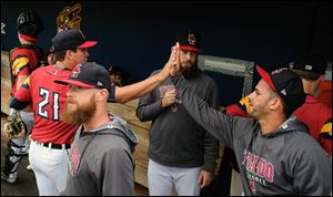 Mud Hens pitcher A.J. Ladwig, left, high fives teammates during a start late last season. Ladwig improved to 3-0 this season with a win at Scranton/Wilkes-Barre Saturday.