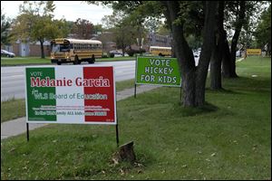 Campaign signs for the Washington Local school board race along Alexis Road near Whitmer High School on Sept. 28.