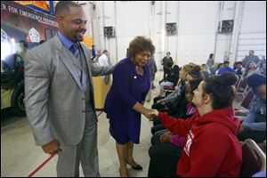 Toledo Public Schools Superintendent Romules Durant, left, and Toledo City Councilman Cecelia Adams, center, shake hands with Destiny Turner, 18, of Rogers High School, after an announcement of a partnership with Owens Community College, City of Toledo, Toledo police and fire, and ProMedica to develop a program that will allow qualified high school students to graduate high school with an opportunity to obtain an EMT basic certification on October 10, 2017. 