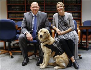 Ottawa County Prosecuting Attorney James VanEerten and Dorry Rimboch, Director of the Victim Assistance program, with public facility dog Helen.