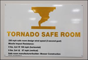 A tornado safe room sign is posted in the safe room at West Side Montessori School Thursday, October 19, 2017 in Toledo.