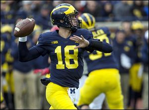 Michigan quarterback Brandon Peters (18) throws a pass in the second quarter of an NCAA college football game in Ann Arbor, Mich., Saturday, Oct. 28.