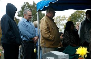 7-Eleven store manager David Fournier, 2nd from left, attends the funeral for his longtime store employee Alice Foster at Lake Township Cemetery in Millbury, Ohio.