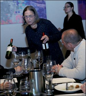 Rachel Nasatir serves wine from Chateau Musar during a tasting of Lebanese wines at a dinner prepared by Chris Nixon at Element 112 in Sylvania, Ohio.