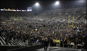 Iowa fans celebrate on the field after Saturday's win over Ohio State. David Briggs ranks Iowa 15th and Ohio State 16th in his most recent AP vote.