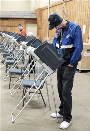 Michael Moore, of Toledo, votes at St. Clement Community Center in the Washington Local School district. Voters in outer wards tended to support Wade Kapszukiewicz.