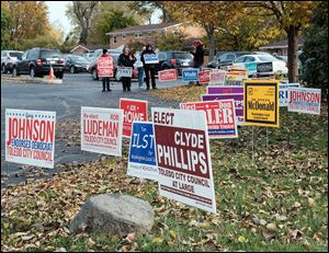 Signs and volunteers outside of St. Clement Community Center in the Washington Local School District in Toledo on November 7.