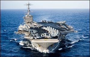 The aircraft carrier USS John C. Stennis transits the Pacific Ocean with the U.S. 7th Fleet in 2012. The Navy has announced that it will run 3-carrier exercises in the western Pacific Ocean for the first time in 10 years, beginning Saturday.