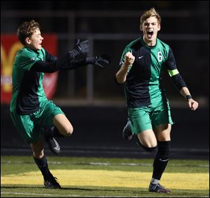 Ottawa Hills' Kevin Hileman, right, celebrates scoring the game winning goal against Kidron Central Christian with teammate Daniel Durst. A 1-0 win at  Clyde High School put Ottawa Hills in Saturday's state championship match.