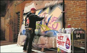 Graffiti artist Tony Touch performs during the Buckeye Community Arts Network premiere at Maumee Bay Brewing Company.