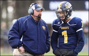 Whiteford head coach Jason Mensing talks with quarterback Thomas Eitniear during a game this year. Mensing has been named The Blade's coach of the year.