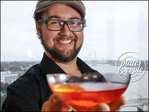 Bartender Brad Somogye with The Heights' signature drink, the Skyway River Crossing.