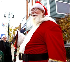 Frank Alcorn of Swanton walks the streets of downtown Grand Rapids, Ohio in a Santa Claus costume during the Christmas Open House last year. This year's Open House takes place Saturday and Sunday.