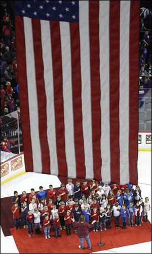 Students from Ottawa River Elementary School sing the National Anthem before a Toledo Walleye game at the Huntington Center in 2016.