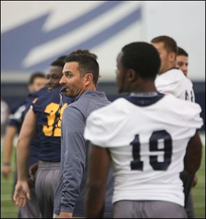 Toledo offensive coordinator/quarterbacks coach Brian Wright, center, has been nominated for the Broyles Award, which honors the top assistant coach in Division I football.