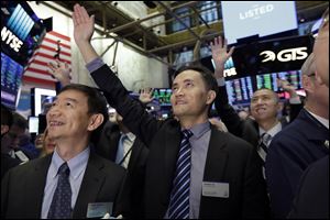 Jianpu Technology's co-founder & CEO Daqing Ye, center, waves to a gallery in the New York Stock Exchange as he waits for his company's IPO to begin trading.