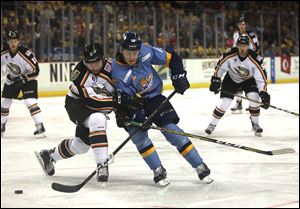 Toledo's Patrick McCarron goes for the puck during a game against Quad City. McCarron and goaltender Matej Machovsky were called up to Grand Rapids of the American Hockey League Friday. 
