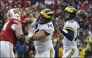 Michigan quarterback Brandon Peters throws a pass against Wisconsin. Peters would later suffer a head injury in the third quarter.