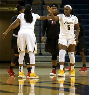 Toledo's Olivia Cunningham, left, a Mississippi native, and Sarah St-Fort, a native of Canada, high-five. UT's team has players from seven different countries and seven different states.