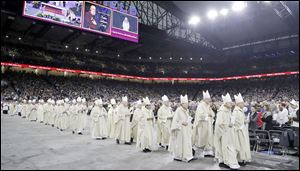 Clergy march in a processional before the Beatification Mass ceremony for Father Solanus Casey, the second U.S.-born man to be beatified by the Catholic Church, in Detroit. About 150 Toledoans attended the ceremony on Saturday.