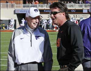 John Wagner's reasons for keeping Oklahoma State in his Super 16? The Cowboys' comeback against Kansas State, a close loss to Oklahoma, and the mullet on head coach Mike Gundy, right.