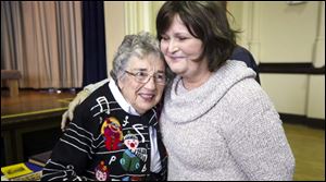 Former music teacher Janet Keener, who taught at Harvard for 35 years, gets a hug from teacher Michele Pass.