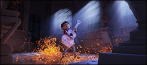 This image released by Disney-Pixar shows characters Miguel, voiced by Anthony Gonzalez in a scene from the animated film, 