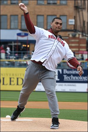 Whitmer graduate and Michigan football player Chris Wormley throws out the first pitch of Toledo Mud Hens home opener April 13, 2017, at Fifth Third Field in Toledo.