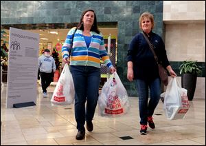 Morenci, Mich. residents Judy Pfund, left, and Julie Kauffman leaave JC Penney as they shop on Black Friday at the Franklin Park Mall in Toledo.