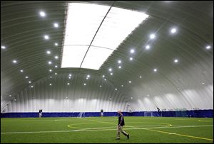 Steve Bach, facility manager at Total Sports Rossford, walks through the 85,000-square-foot dome in Rossford, Ohio. Rossford Mayor Neil MacKinnon says the proposed facility in Wood County could boost the two domes there rather than detract from them.