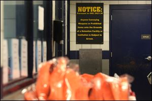 A view of the intake area, including a sign warning against contraband, taken on Friday, November 17, 2017, at the Lucas County Jail in Toledo. 