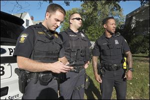 Sgt. Kevan Toney, left, Tweets after a foot pursuit on Boydson near Monroe Street with Officers Ei McCord, middle, and Jeron Ellis, all of the Toledo Police Department.  