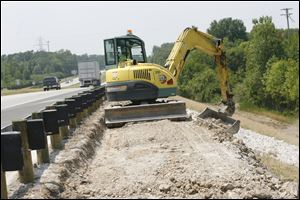 A crane does embankment repair work along SR 2 between Port Clinton and Camp Perry on July 9, 2007.