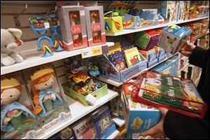 Sarah Smith checks out customers inside Learning Express Toys at the Shops at Fallen Timbers in Maumee. 