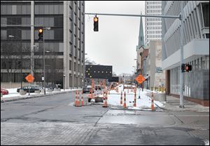 Erie Street and Madison Avenue in downtown Toledo. A completion of a water main replacement project has been pushed back to January.