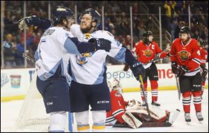 Toledo's Austen Brassard celebrates scoring a goal with Charlie O'Connor, right, Wednesday at the Huntington Center.