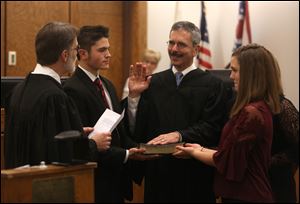 Michael Bonfiglio is sworn in by Lucas County Common Pleas Judge Dean Mandros at Sylvania Municipal Court. Bonflglio is the first new Sylvania Municipal Court judge in 30 years.