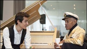 Pianist and composer Guy Mintus, left, and chats with  renowned lyricist and singer Jon Hendricks, who began his career in Toledo, at the Toledo Museum of Art Glass Pavilion. In 2000, Mr. Hendricks returned to Toledo to teach at the University of Toledo. He died in November in Manhattan at age 96.