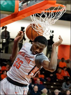 Bowling Green State University guard Daeqwon Plowden (25) dunks the ball against Lourdes College during a game December 28 at the Stroh Center in Bowling Green.