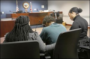 Demetrius Wimberly, 14, center, is comforted as he is arraigned on the charge of murder Wednesday, December 27, 2017, at Lucas County Juvenile Court in downtown Toledo. Wimberly is one of four boys charged in the death of Marquise Byrd, 22. 