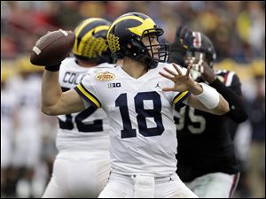 Michigan quarterback Brandon Peters (18) finished 20-of-44 for 186 yards and two interceptions in a 26-19 lost against South Carolina in the Outback Bowl.