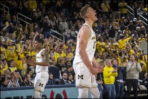 Michigan forward Moritz Wagner, foreground, react to a 3-point basket by guard Charles Matthews, left, during Tuesday's game against Purdue.