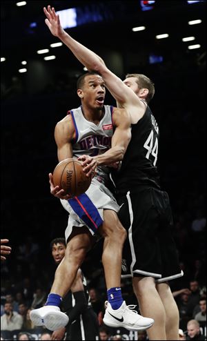Detroit Pistons' Avery Bradley drives past Brooklyn Nets' Tyler Zeller.