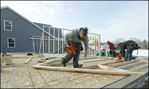 Adam Brenneman Construction worker James Smeltzer, left, helps build a wall for a single family home on McCord Rd. in Sylvania at the Woodland Hills development.