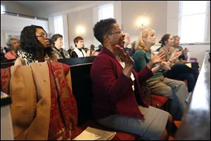 Rev. Ruby Radford, from Cass Road Baptist Church in Maumee, applauds a performance during a commemoration worship service to honor  Dr. Martin Luther King Jr. at First Presbyterian Church on January 14, 2018.