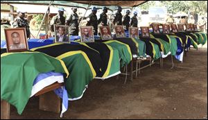 U.N peacekeepers stand behind coffins with the remains of Tanzanian peace keepers who were killed by rebels on Dec. 8, 2017, in the eastern Democratic Republic of Congo.