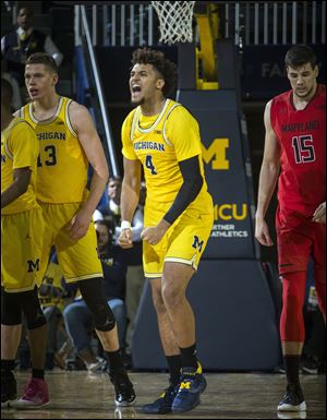 Michigan forward Isaiah Livers (4) celebrates making a three-point basket in the second half of Monday's game in Ann Arbor.