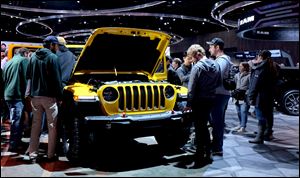 The Jeep Wrangler is surrounded at the North American International Auto Show at the Cobo Center in Detroit.